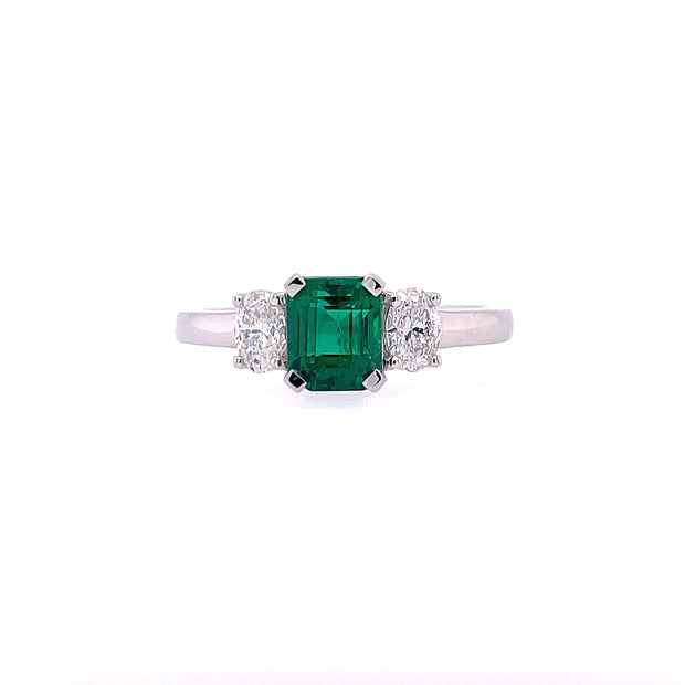 18K White Gold Ring Featuring Center .90CT Emerald With Two Side Oval Diamonds For A Total Weight Of .37CT